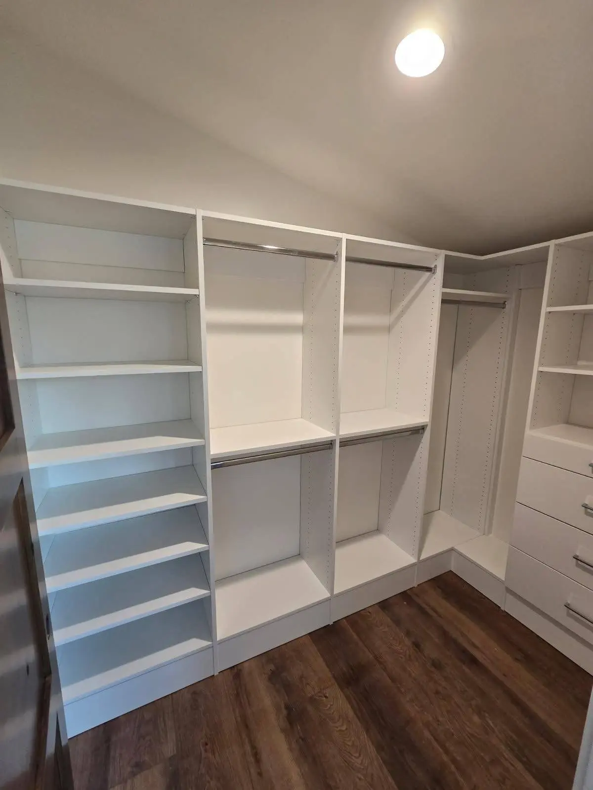 Walk in closet system with hanging rods, shelves and drawers