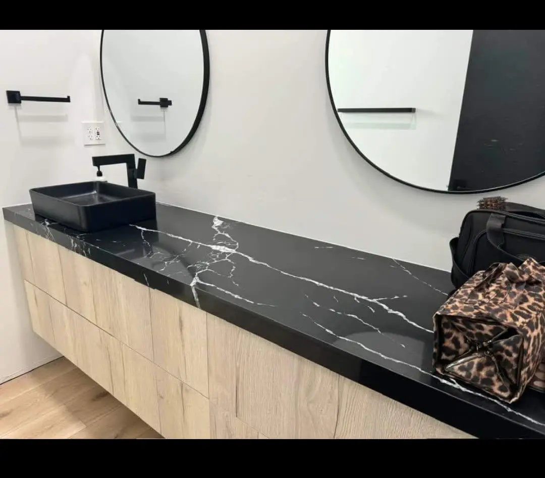 Floating bathroom vanity with black marble top by DC Cabinets