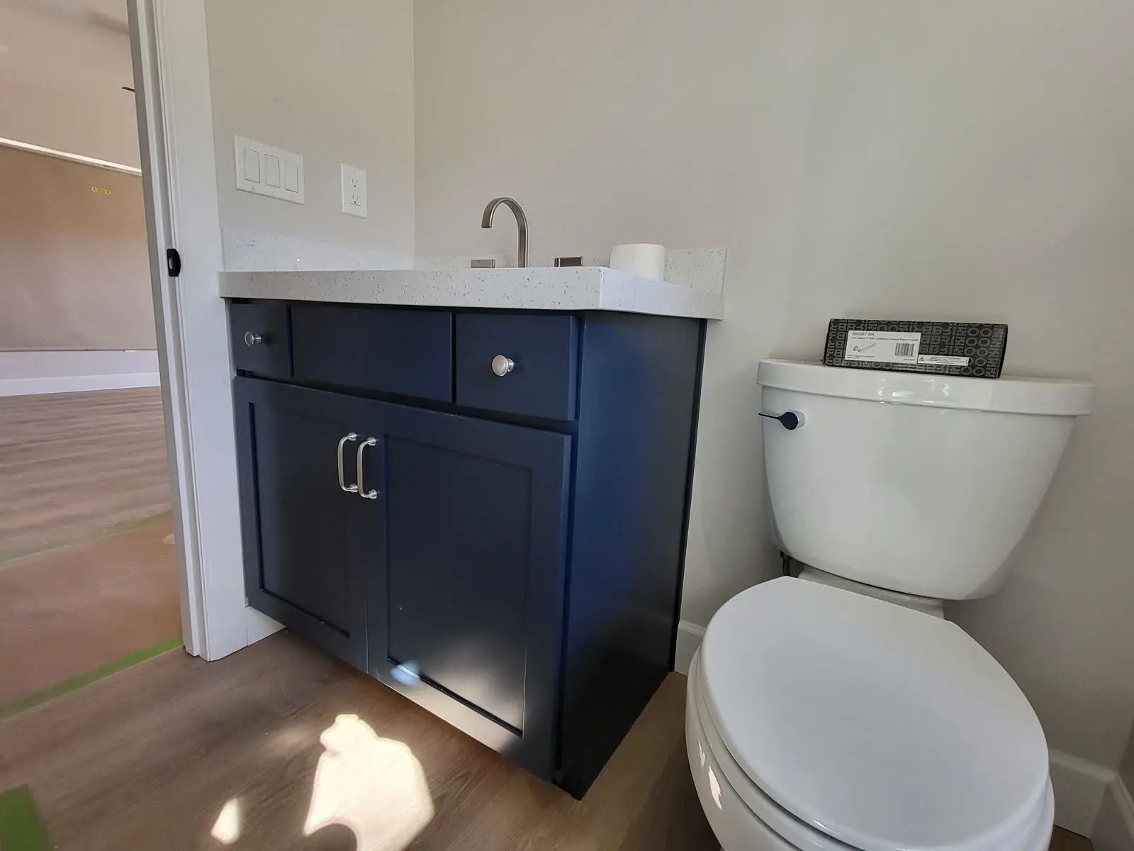 Navy blue bathroom vanity with shaker doors by DC Cabinets