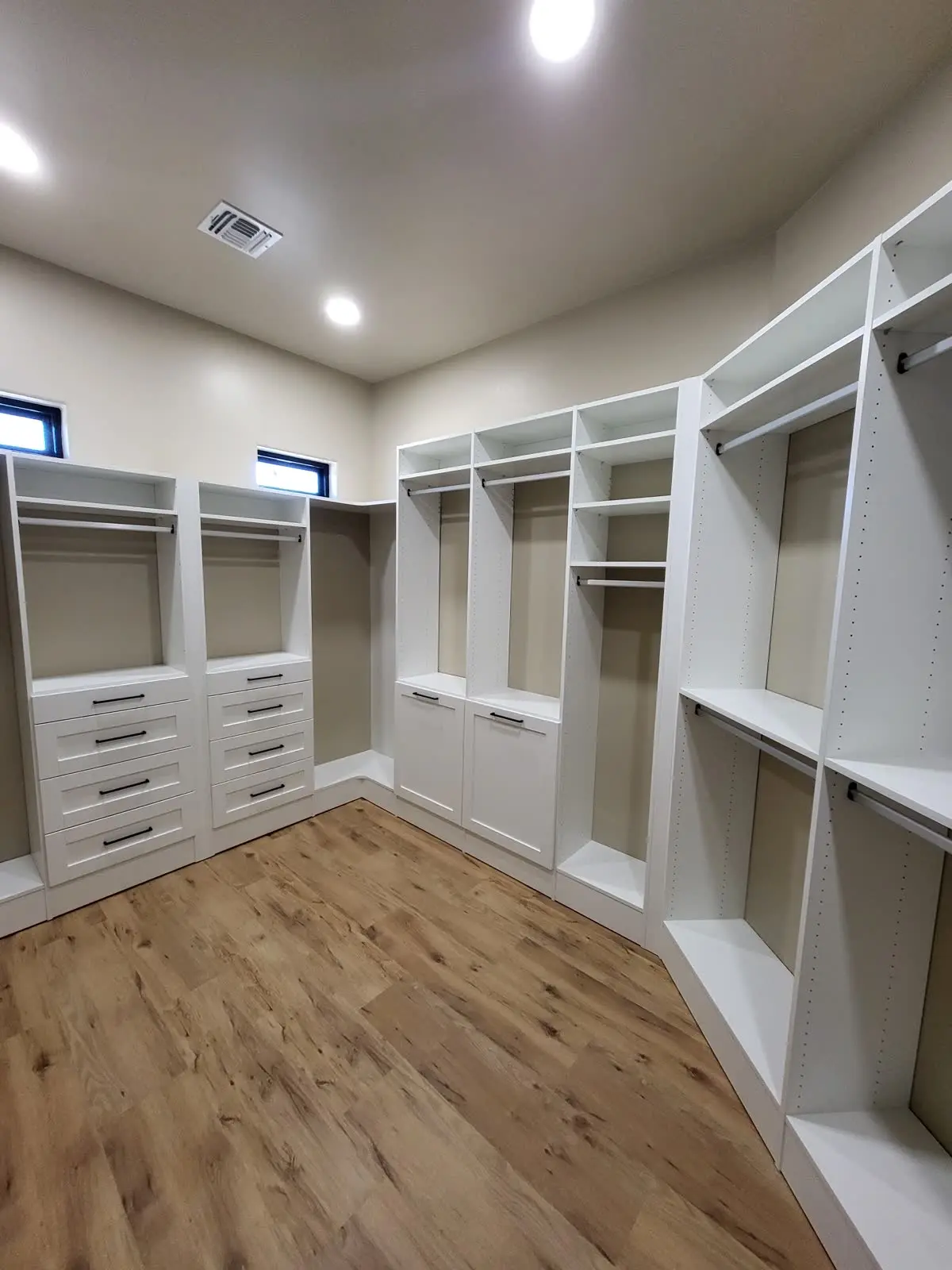 White walk-in closet with drawers and shelving by DC Cabinets